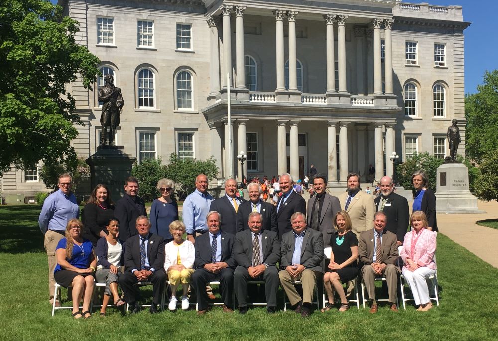 Group photo outside the NH State House for members of the Bicentennial Commision. Eileen is sitting in the front row on the right end.